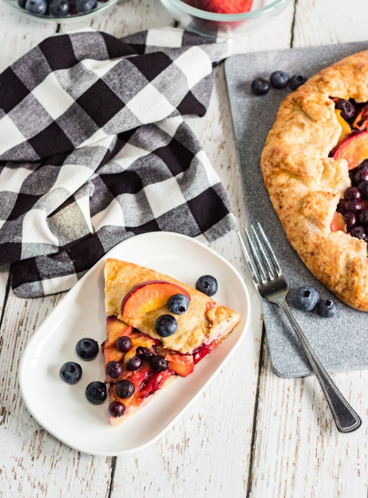 peach blueberry galette on a serving plate