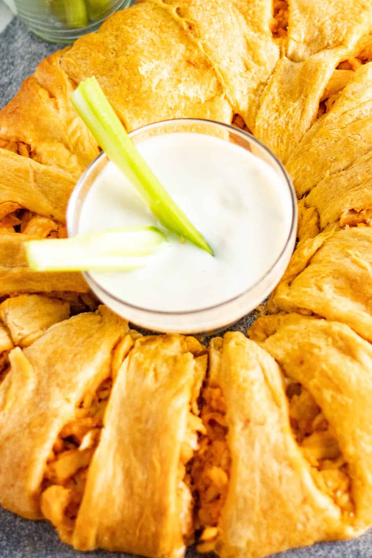 buffalo chicken crescent ring with blue cheese and celery in dish the middle