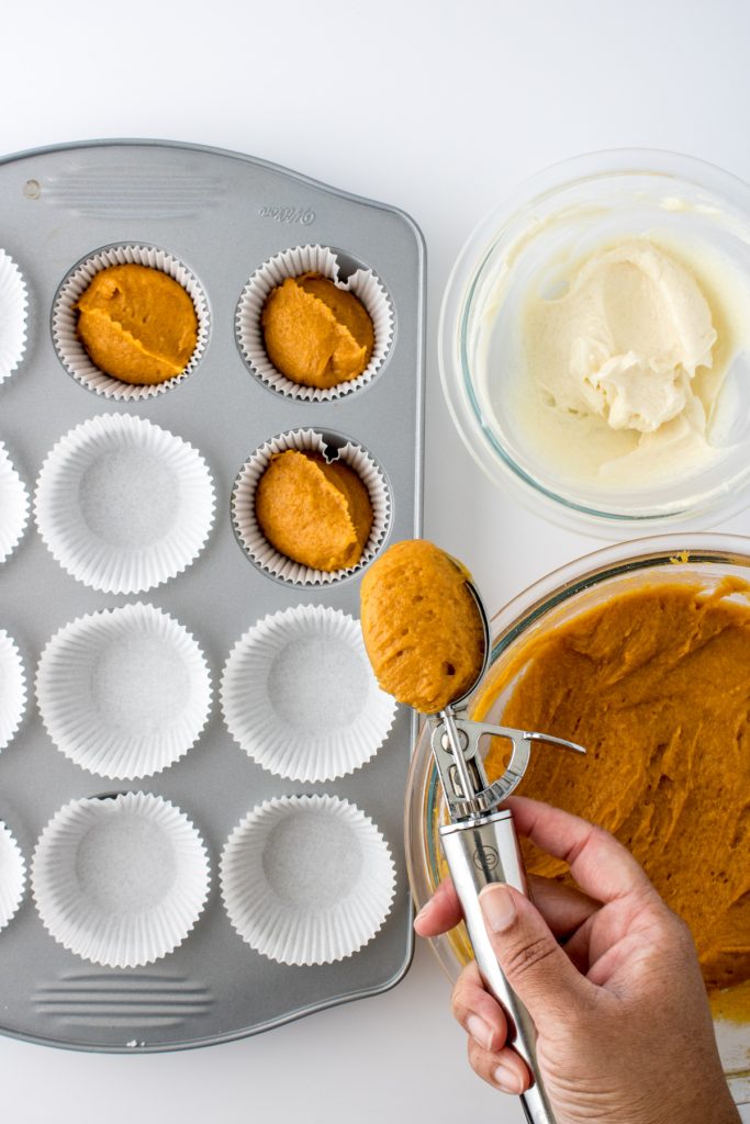 adding the muffin batter to the muffin cups