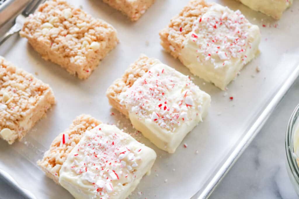 finished rice crispy treats spread with white chocolate and sprinkled with peppermint candy