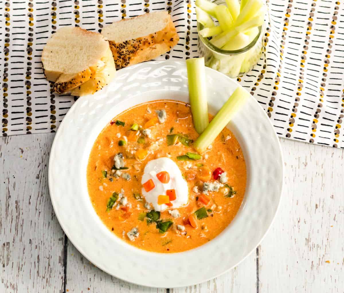 buffalo chicken soup in white bowl with celery