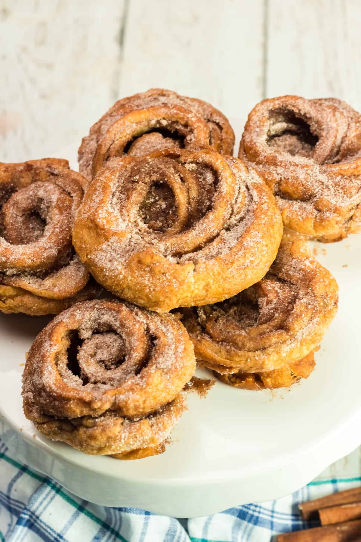 cinnamon sugar cruffins stacked on a white plate