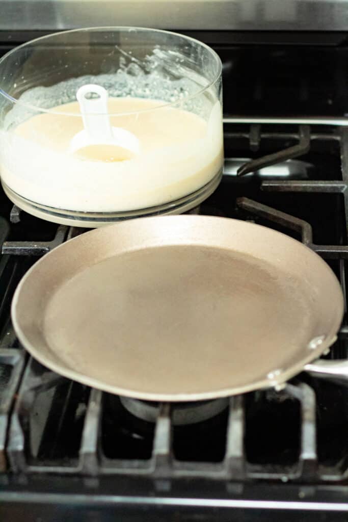 crepe pan on stove with crepe batter