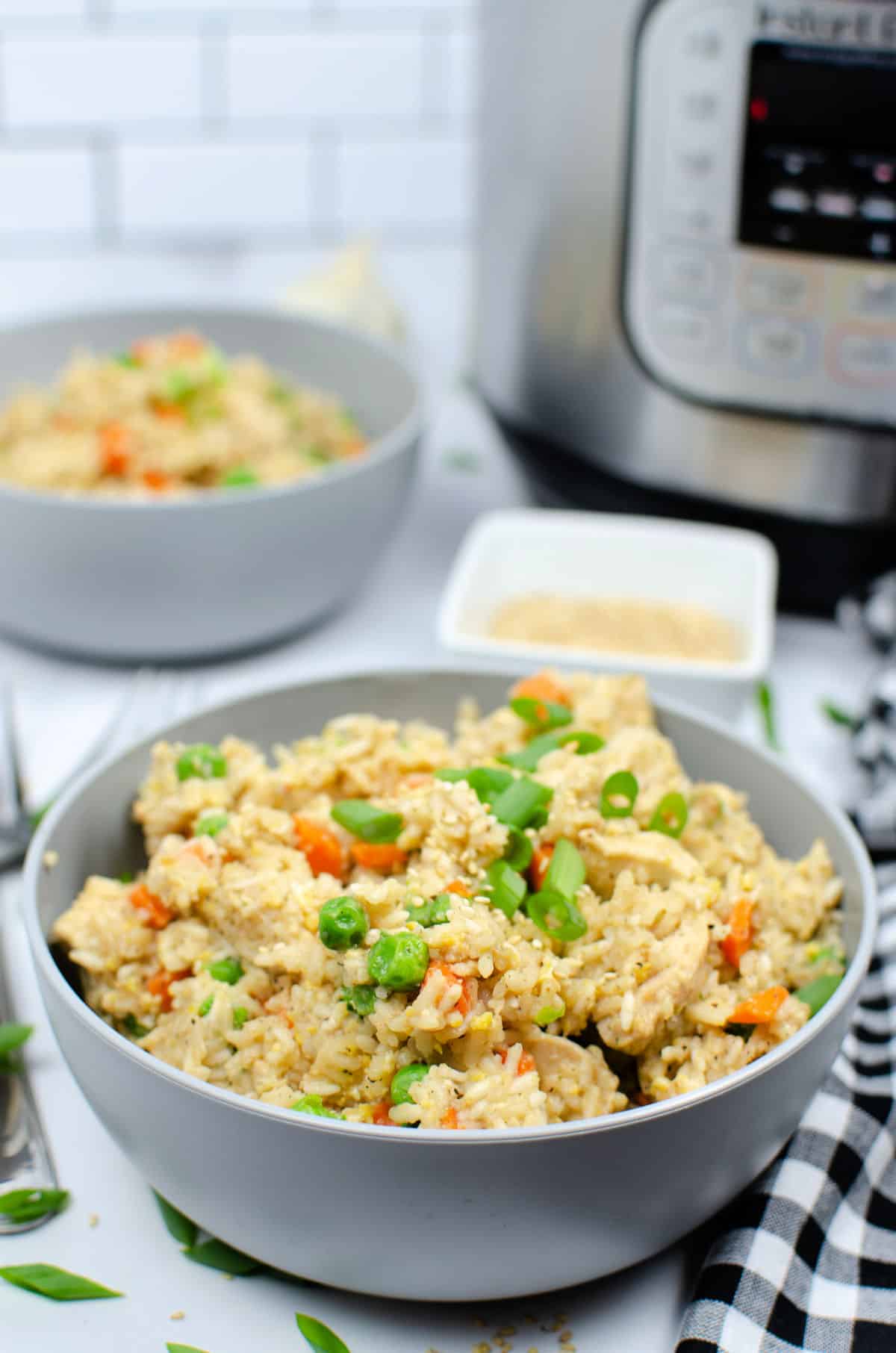 chicken fried rice in bowl with instant pot in background