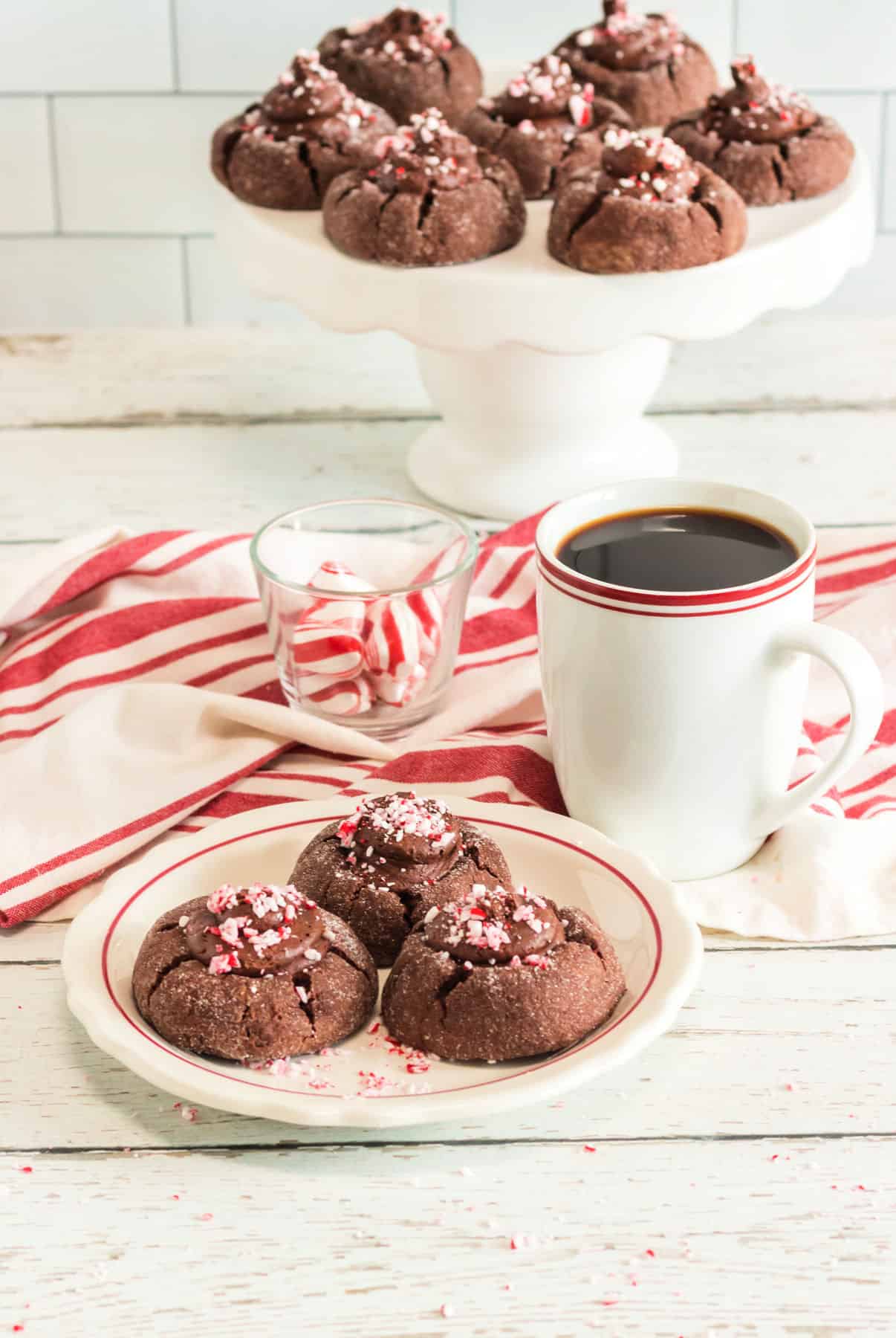 chocolate peppermint cookies on cake stand and plate with coffee