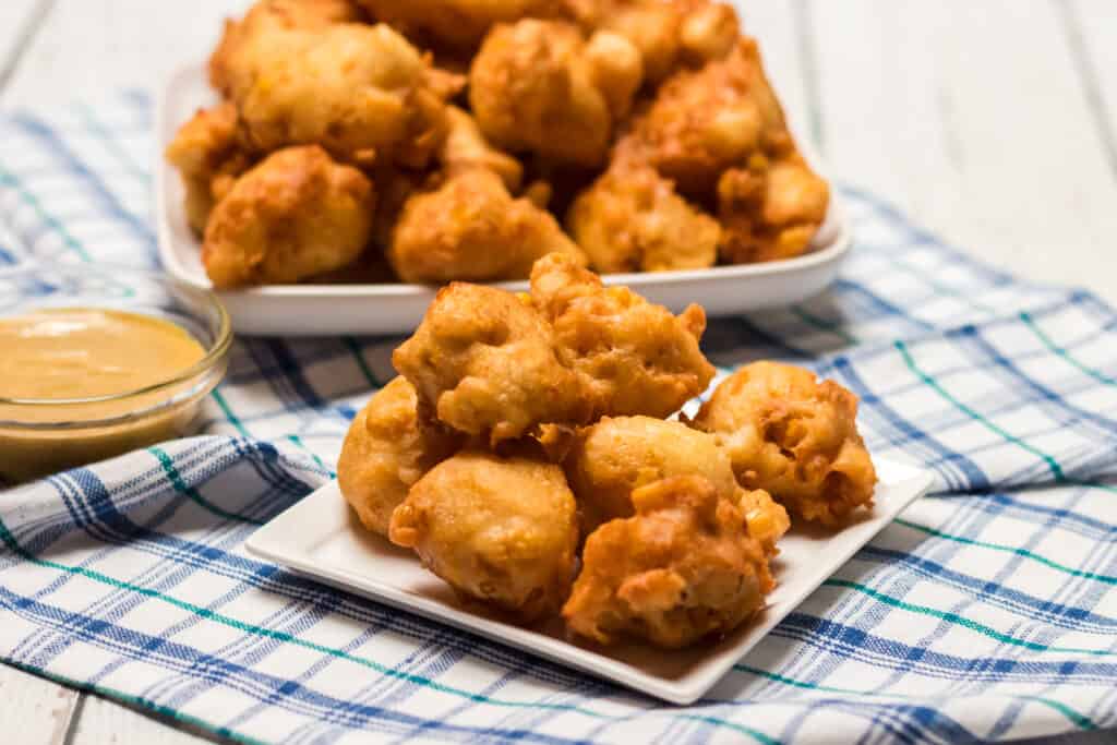 deep fried corn nuggets on white plate