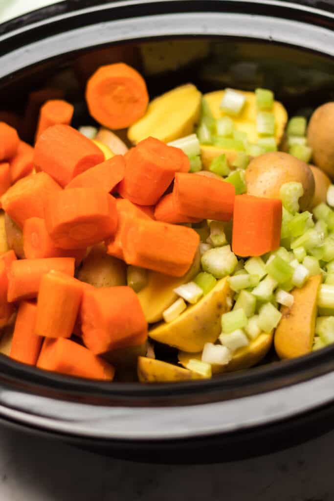 add in vegetables in crockpot over beef