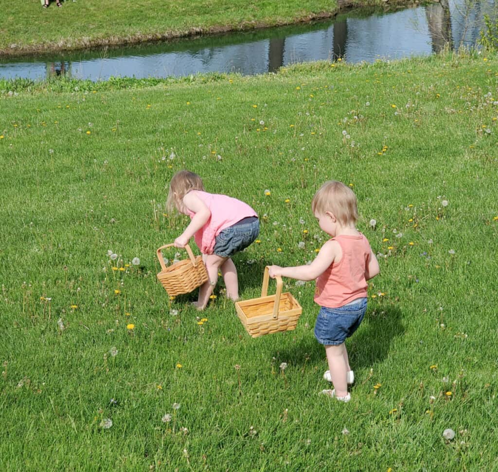 2 girls picking dandelions