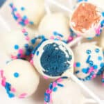 gender reveal cake pops on white plate