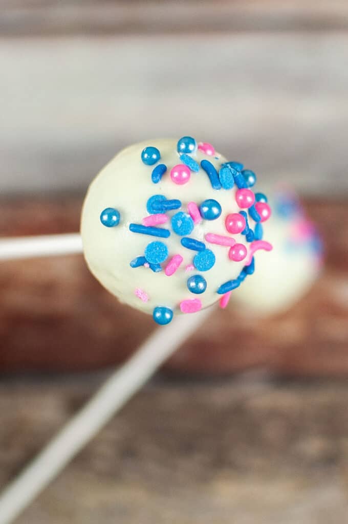finished cake pop with white coating and sprinkles
