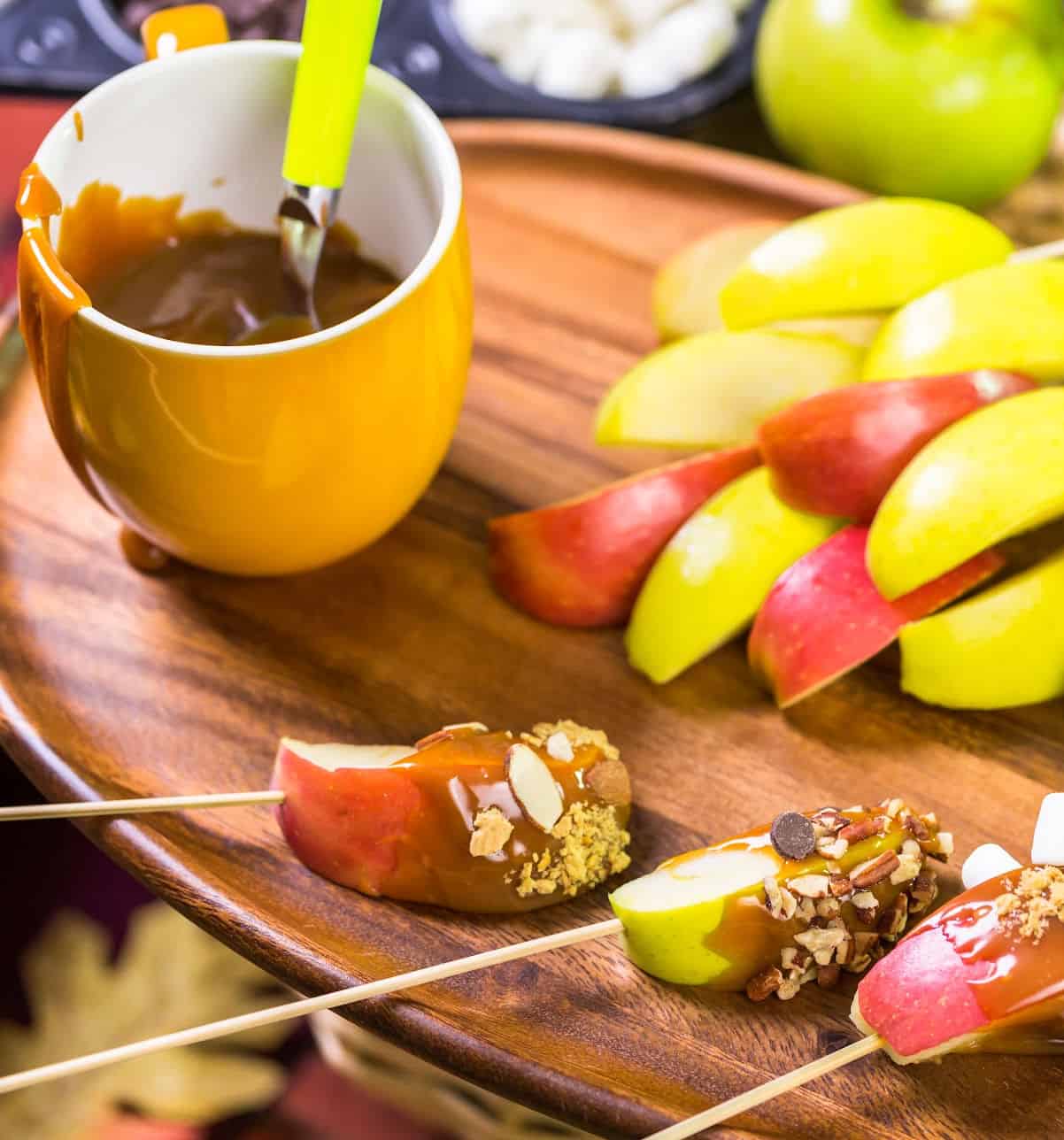 apple slices dipped in caramel and coated in nuts