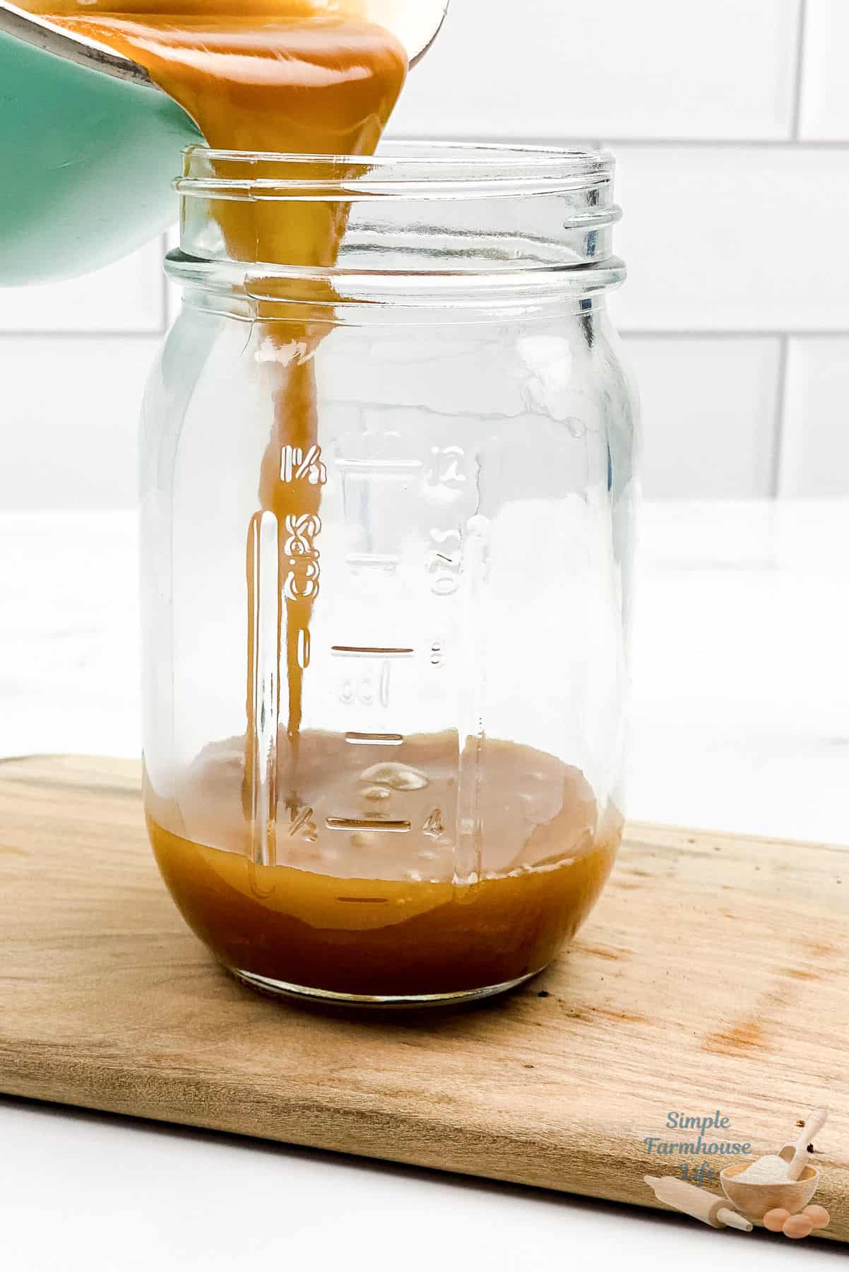 pouring caramel dipping sauce into jar