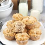sourdough discard cinnamon muffins stacked on white plate with milk