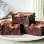 condensed milk brownies stacked on a plate