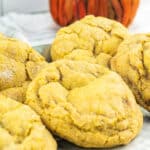 pumpkin cream cheese cookies with pumpkin in background